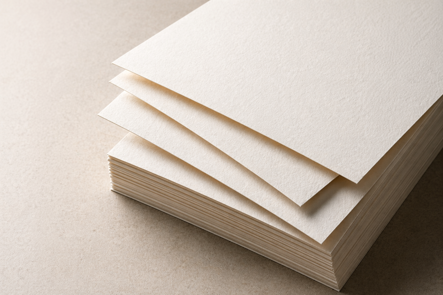 Stack of premium paper sheets on a warm neutral background